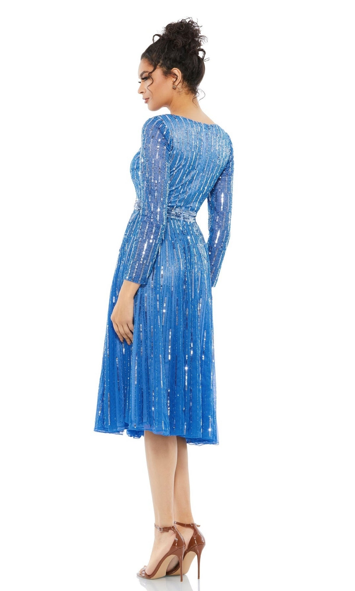 Woman wearing the Short Semi-Formal Dress 5528 by Mac Duggal—a blue sequined, belted midi dress—paired with nude high-heeled sandals, poses with her back slightly turned.